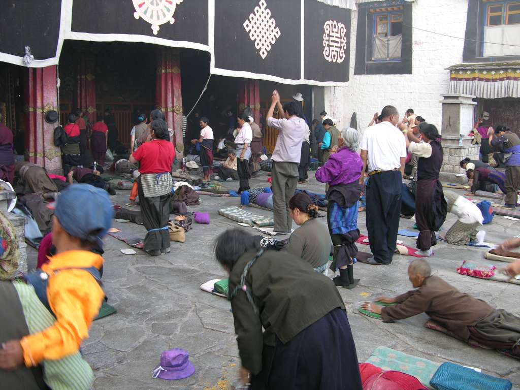 03 Prostration A prostration is one of the fundamental practices of Tibetan Buddhism to purify our pride, body, speech and mind. You begin with your palms pressed together at the level of your heart, and then touch your hands to your crown point between the eyebrows (mind), the throat (speech), and the heart (body), then stretch your entire body on the ground and stretch both of your hands as far as possible away from your head. Then rise up quickly and repeat at least two more times.